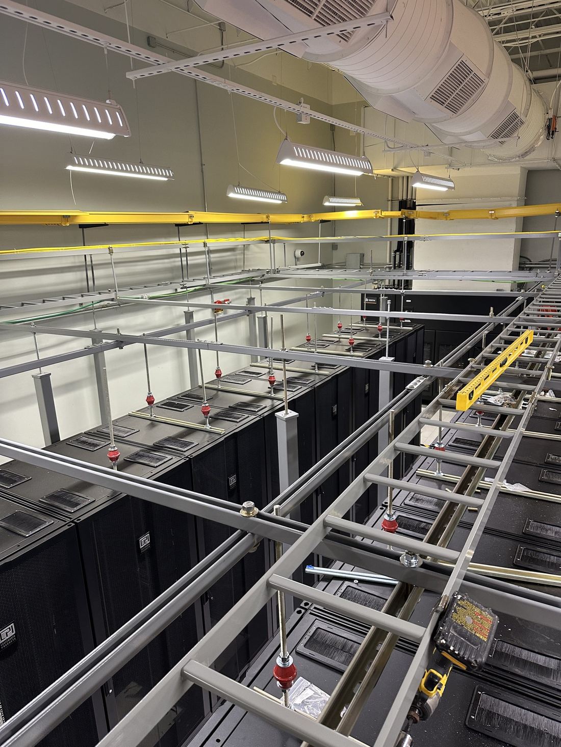 Cable ladder rack run over cabinet row in electrical room