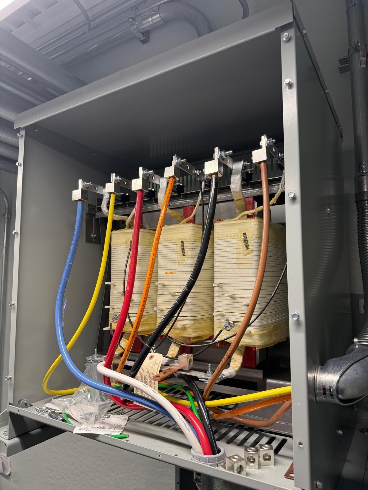 Dry-type transformer internal wiring with color-coded phase leads